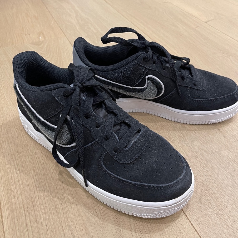 black suede Nike sneakers with detailed nike swoosh